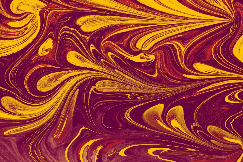 Dynamic marbled abstract design in warm red and yellow tones, ideal for backgrounds and textures.